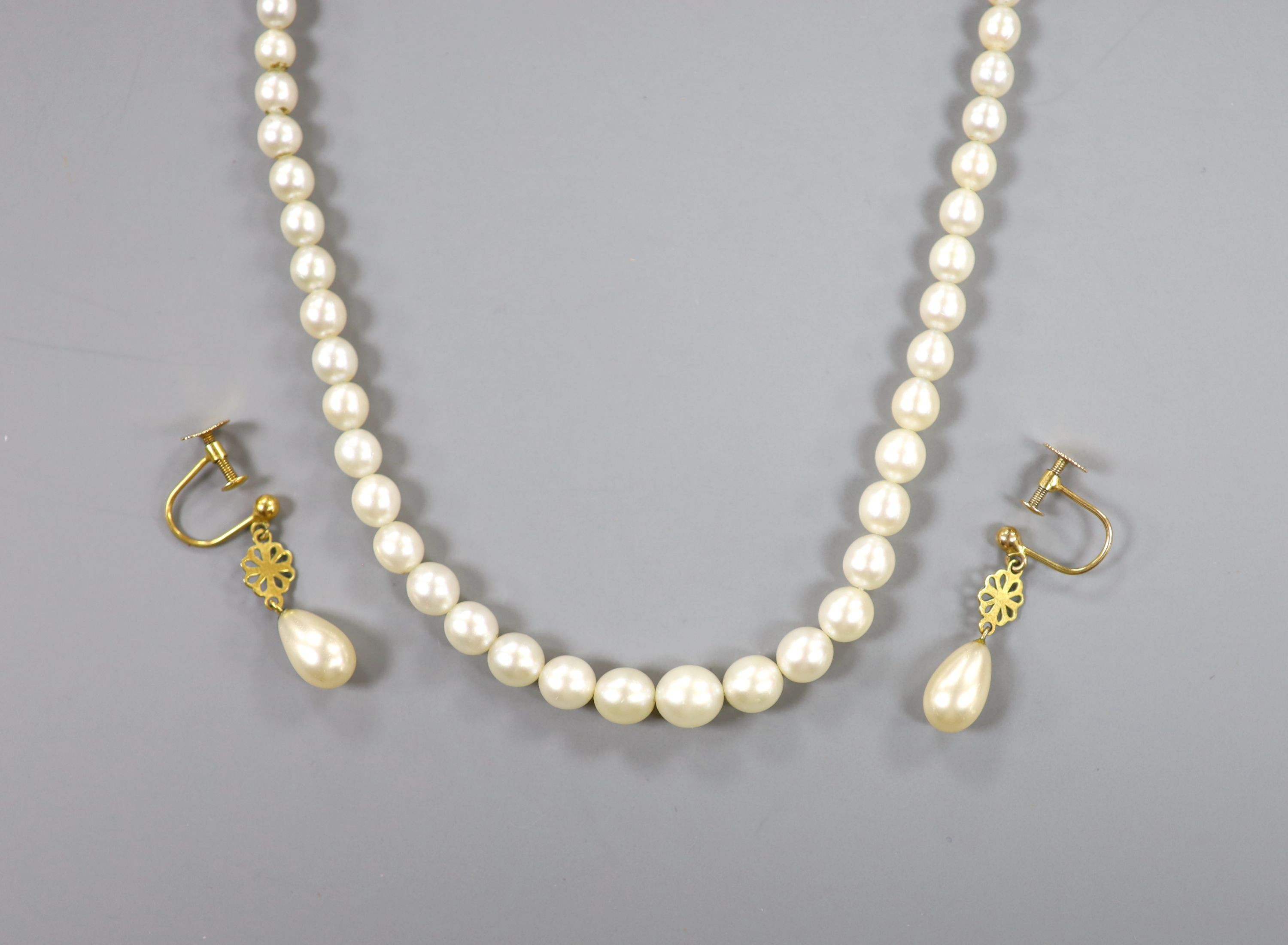 A single strand and graduated cultured pearl necklace, with marcasite set clasp, 44cm and a pair of 9ct and simulated pearl drop earrings.
